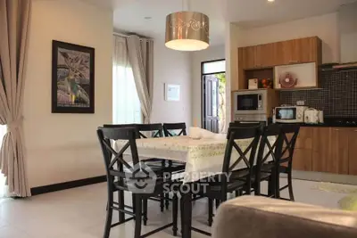 Charming open-layout kitchen and dining area with modern decor and natural light.