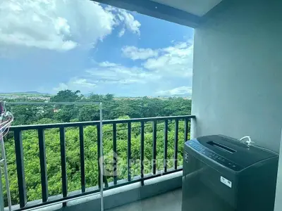 Spacious balcony with lush green view and modern washing machine, perfect for relaxation and convenience.