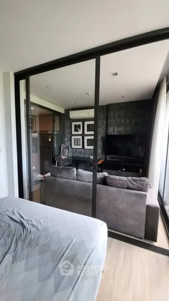 Modern living room with glass partition and cozy sofa in stylish apartment