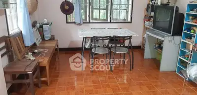 Cozy dining area with vintage TV and wooden furniture, perfect for small gatherings.