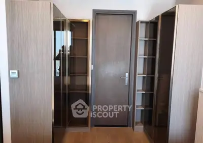Modern storage room with sleek wooden cabinets and glass doors