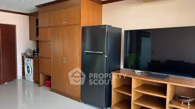 Spacious living area with modern appliances and sleek wooden cabinetry