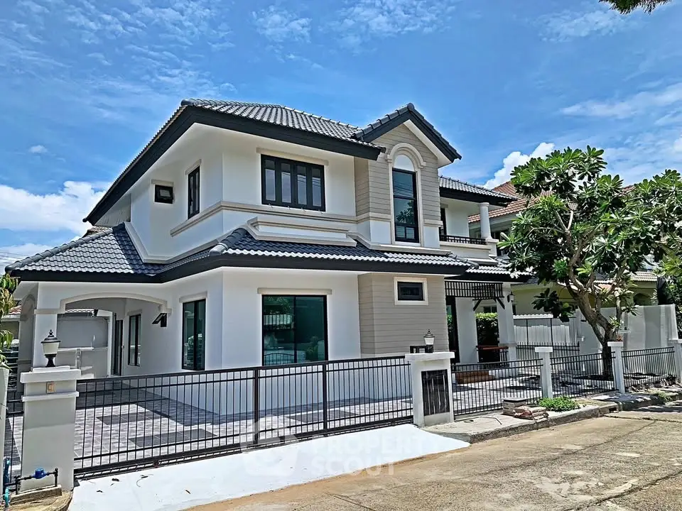 Stunning two-story modern house with elegant design and spacious driveway.