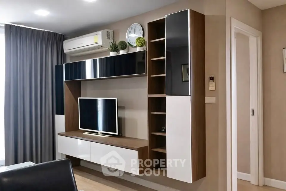 Modern living room with sleek TV unit and air conditioning, perfect for urban living.