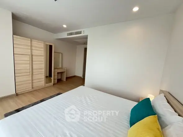 Spacious bedroom with modern decor and ample natural light.