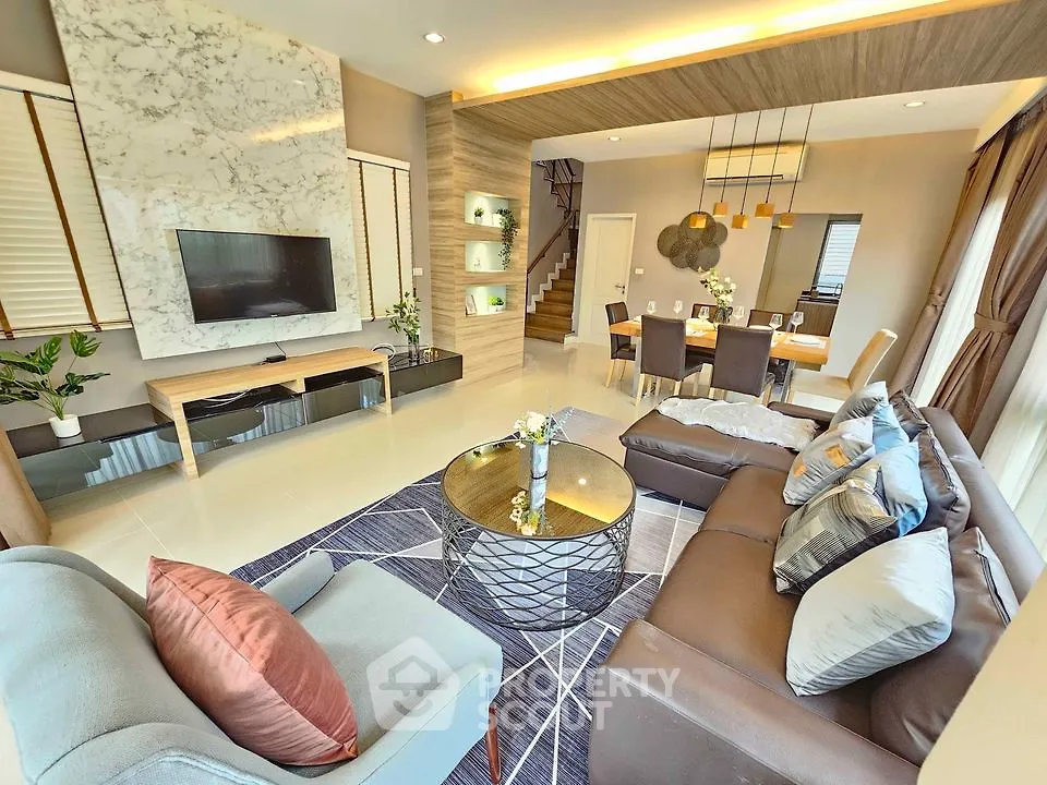Luxurious modern living room with elegant decor and open dining area, perfect for stylish living.