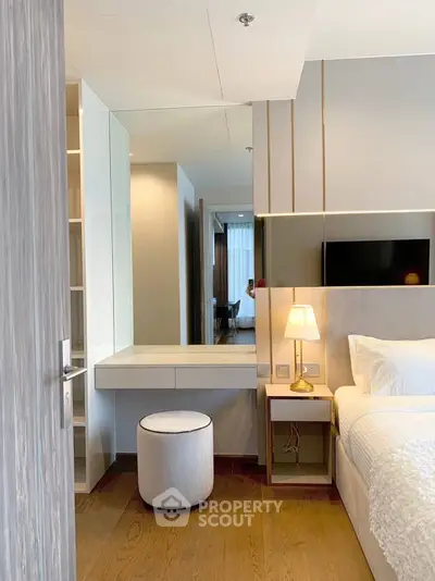 Luxurious bedroom with modern decor and elegant lighting, featuring a cozy bed and stylish vanity area.