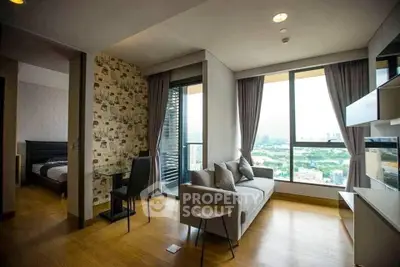 Modern living room with large windows offering stunning city views, stylish decor, and cozy ambiance.