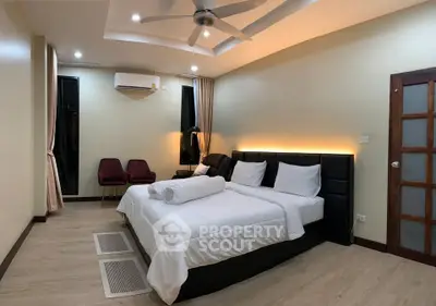 Spacious bedroom with modern decor and ambient lighting