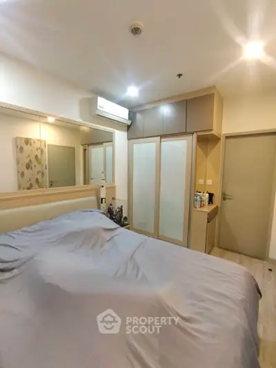 Cozy bedroom with modern design, featuring built-in wardrobe and air conditioning for ultimate comfort.