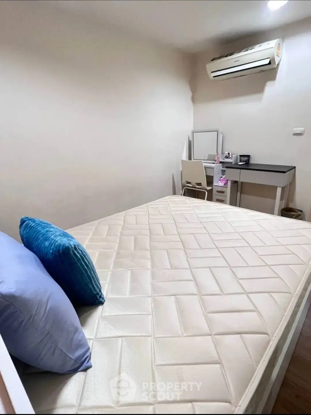 Cozy bedroom with air conditioning and study desk, perfect for comfort and productivity.