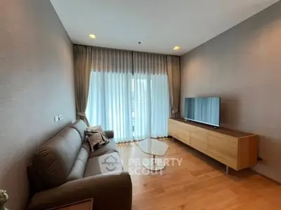Modern living room with sleek furniture and large window for natural light.