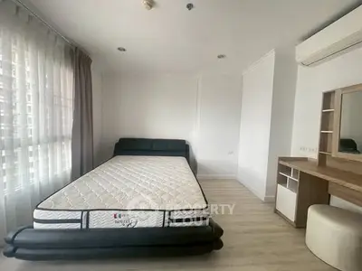 Spacious bedroom with modern furniture and natural light