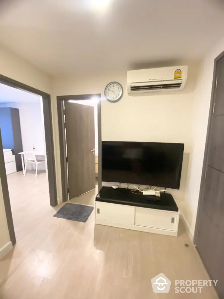 Modern living room with air conditioning and flat-screen TV in a cozy apartment.