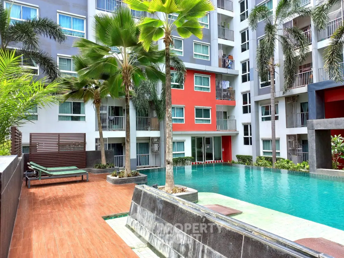 Modern apartment complex with pool and palm trees, ideal for luxury living.