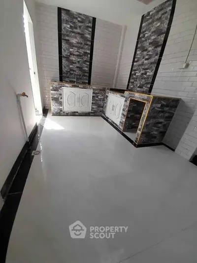 Modern kitchen with sleek tile design and ample space for culinary creativity.
