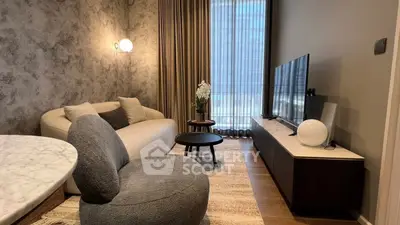 Stylish modern living room with cozy seating and elegant decor in urban apartment.