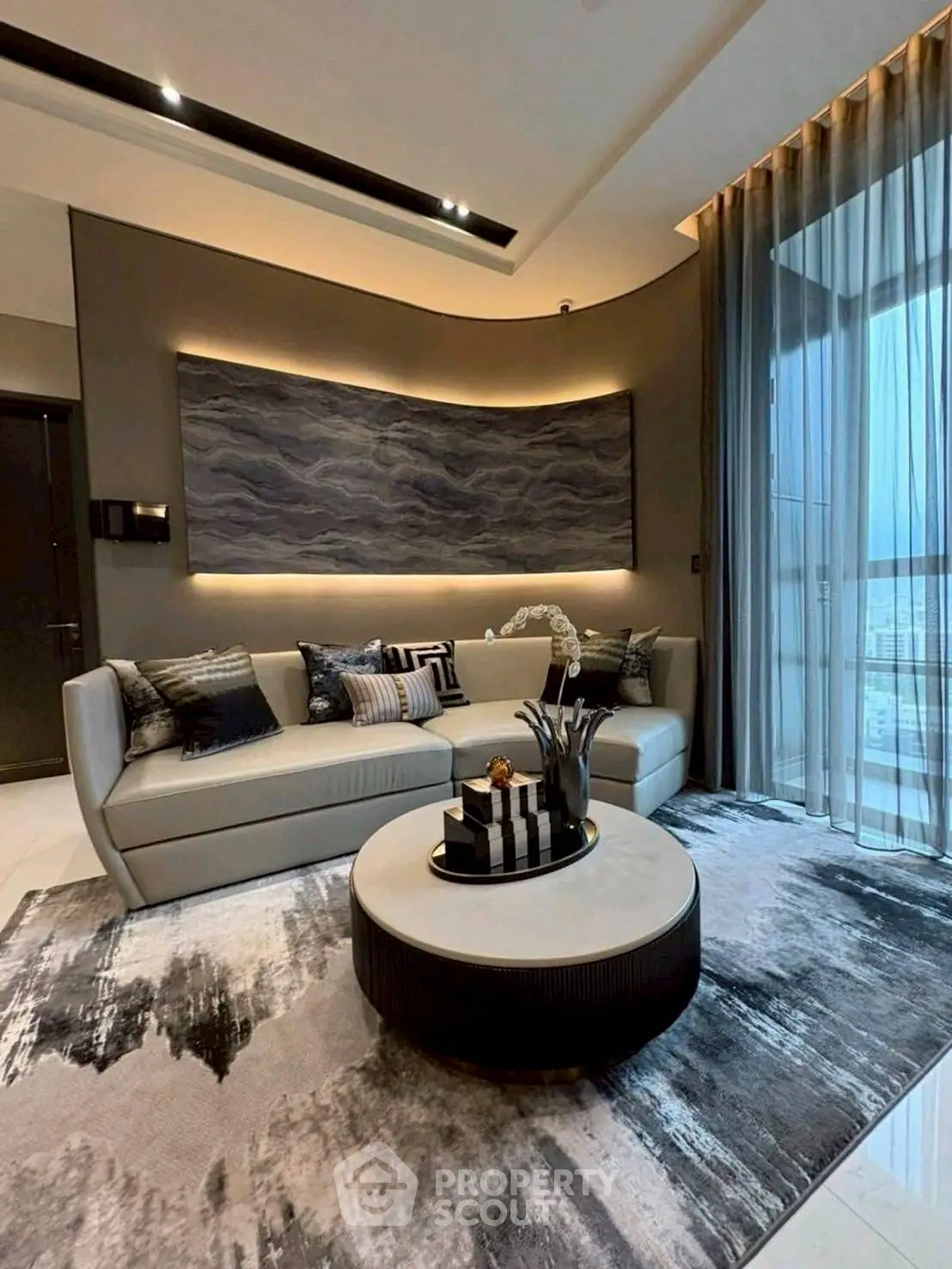 Luxurious modern living room with elegant decor and panoramic window view.