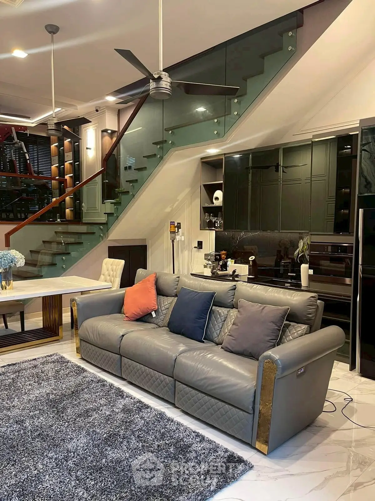 Luxurious modern living room with stylish staircase and elegant decor