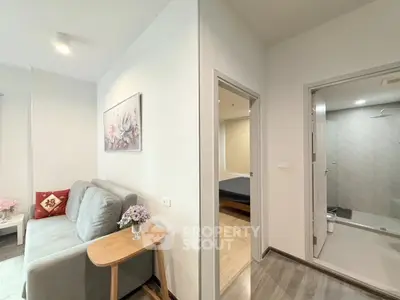 Modern apartment interior with cozy living room and adjacent bedroom, featuring stylish decor and neutral tones.