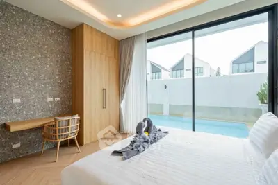 Luxurious bedroom with pool view and modern decor in a stylish home