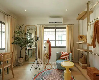 Chic and cozy living room with modern decor and ample natural light, perfect for relaxation and style.