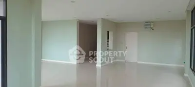 Spacious open-plan living area with modern design and ample natural light.