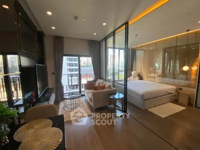 Luxurious modern studio apartment with glass partition, cozy living area, and city view balcony.