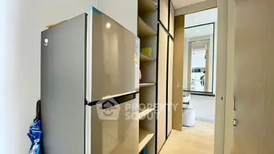 Modern kitchen with sleek fridge and ample storage space