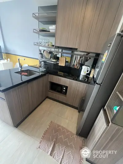 Modern kitchen with sleek cabinetry and built-in appliances in a compact layout.