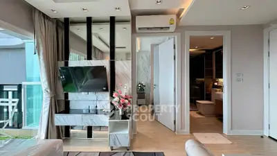 Modern living room with elegant decor and balcony view in a luxury apartment.