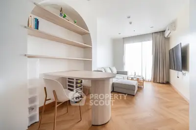 Modern living room with stylish wooden flooring and cozy seating area, perfect for relaxation and entertainment.