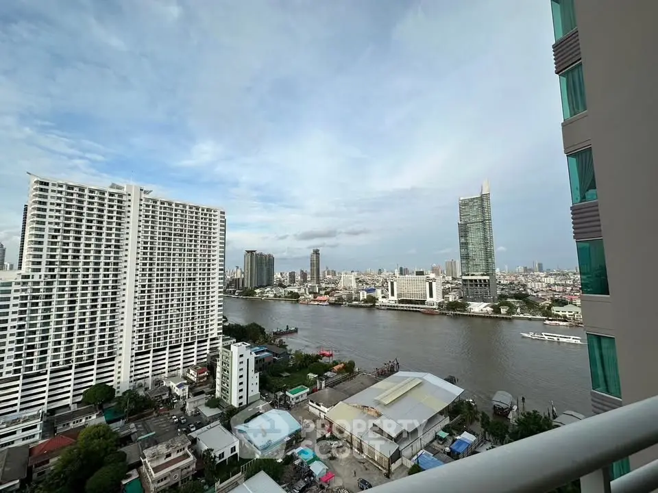Stunning riverfront cityscape view from high-rise balcony in urban setting.