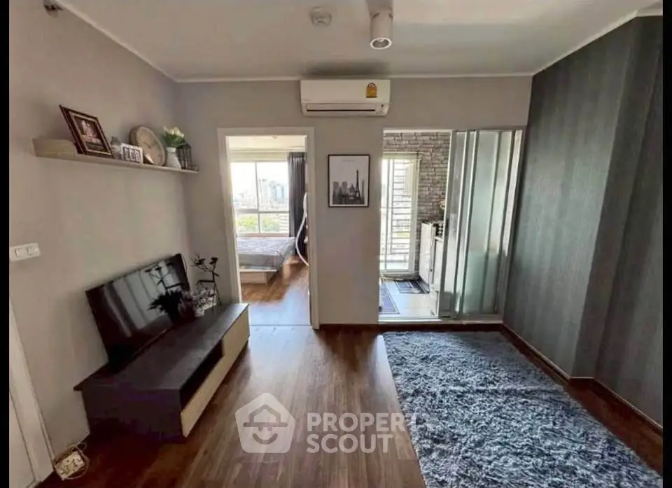 Modern living room with wooden flooring and stylish decor in a cozy apartment.