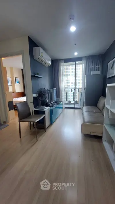 Modern living room with sleek furniture and balcony view in urban apartment