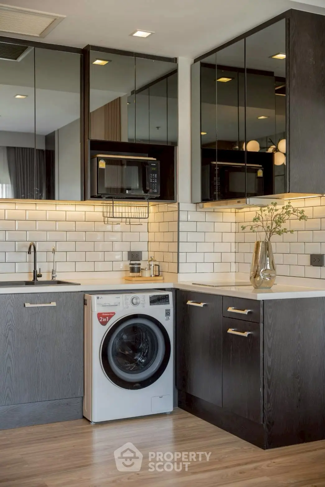 Modern kitchen with sleek cabinetry and integrated washing machine