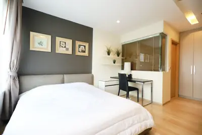 Modern bedroom with stylish decor and workspace in a bright apartment