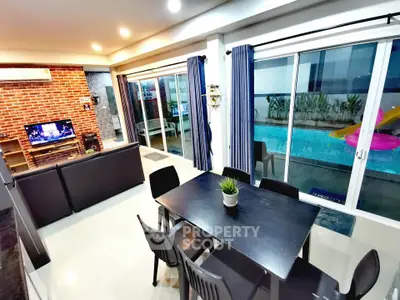 Modern living room with pool view, open layout, and stylish decor