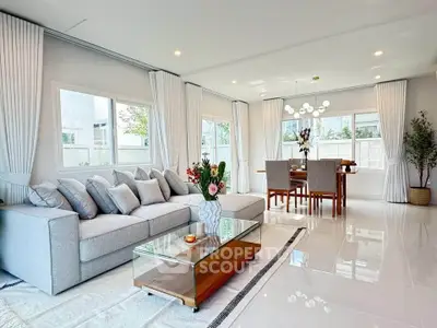 Spacious modern living and dining area with elegant decor and natural light.