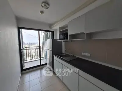 Modern kitchen with balcony view in high-rise apartment