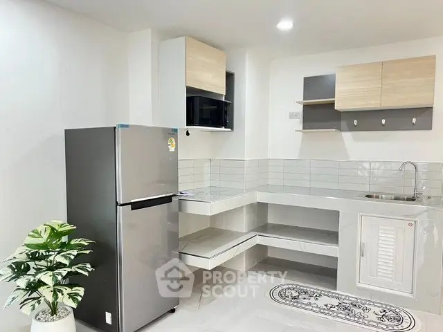 Modern kitchen with sleek design and stainless steel fridge