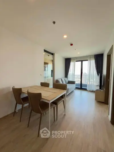 Modern living room with dining area and large window view