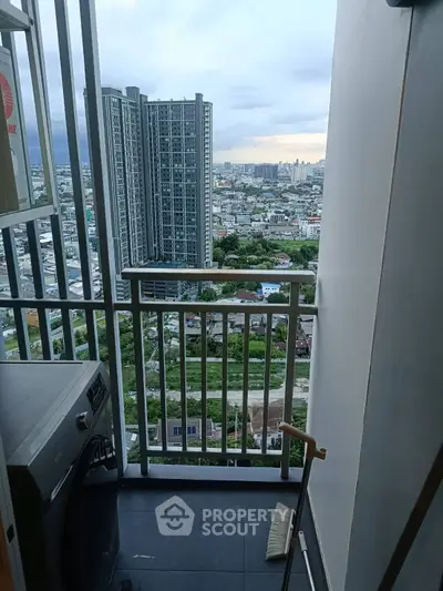 High-rise balcony with cityscape view and washing machine, perfect for urban living.