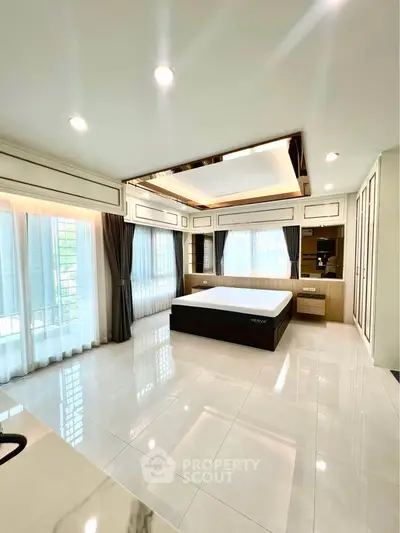 Spacious modern bedroom with large windows and elegant decor