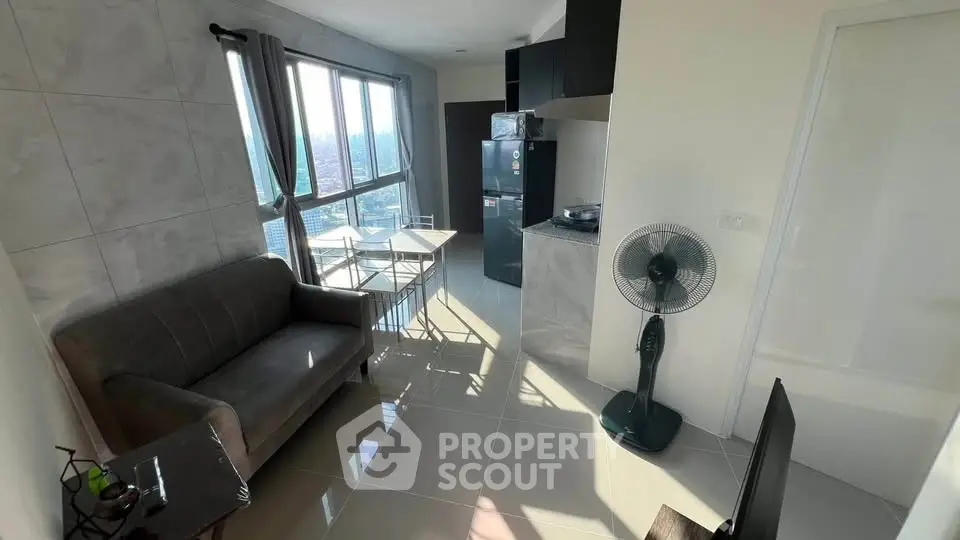 Modern apartment with open layout, featuring a cozy living area and kitchen with city views.