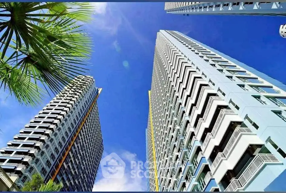 Stunning view of modern high-rise buildings against a clear blue sky, showcasing urban architectural elegance.