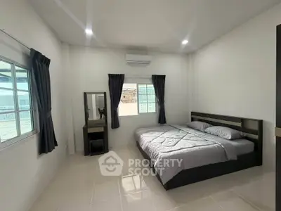 Spacious modern bedroom with natural light and minimalist decor