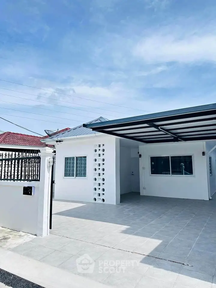 Charming single-story home with modern carport and spacious driveway