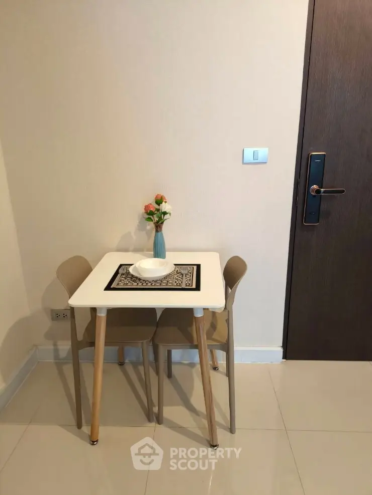 Cozy dining nook with modern table and chairs in a stylish apartment interior.