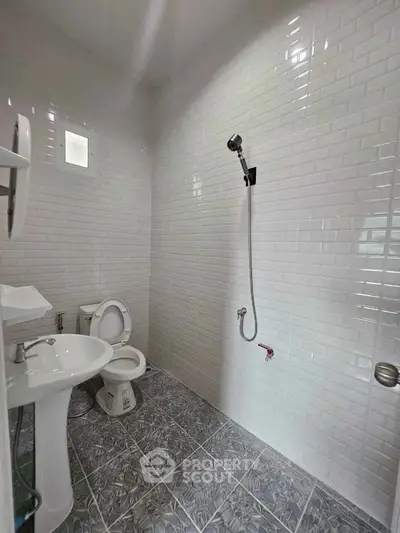 Modern bathroom with white subway tiles and sleek fixtures